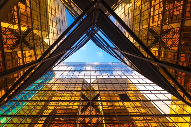 low angle view of Office Buildings in Hong Kong from below, with the sky visible through an X-like cross