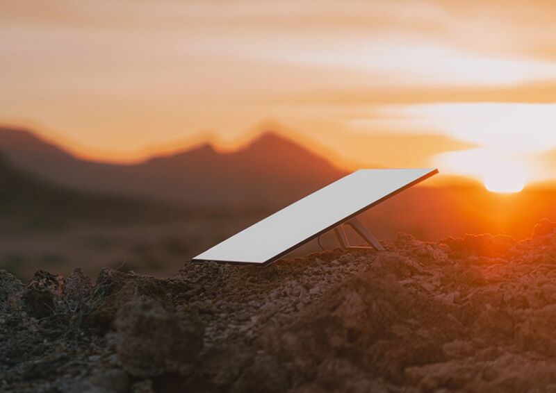 A rectangular satellite dish sitting on the ground outdoors.